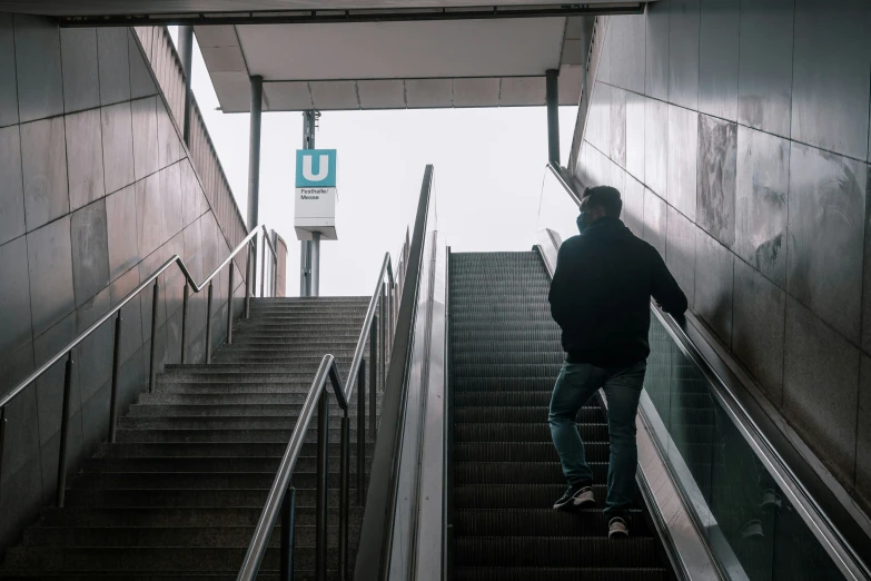 a man that is standing on a stairway