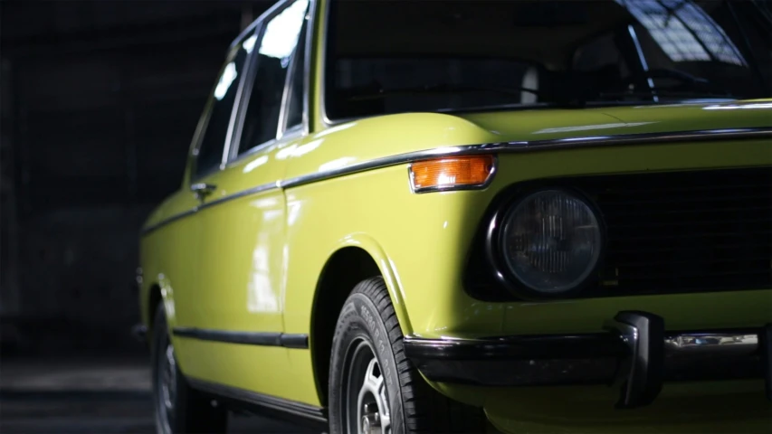 a yellow vintage car with the hood out