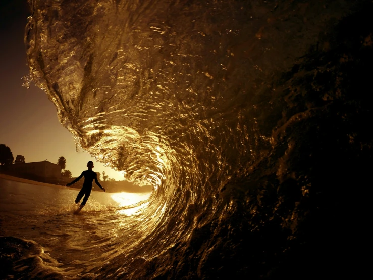 a person is surfing inside of a big wave