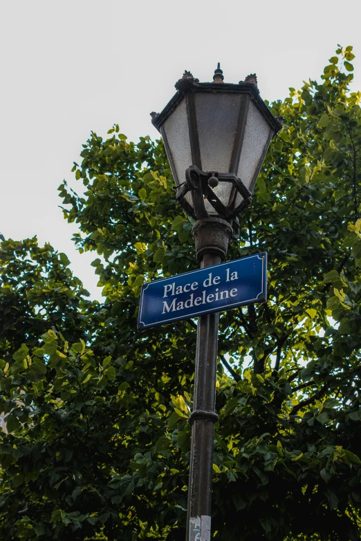 street sign with blue sign that says place de la marche