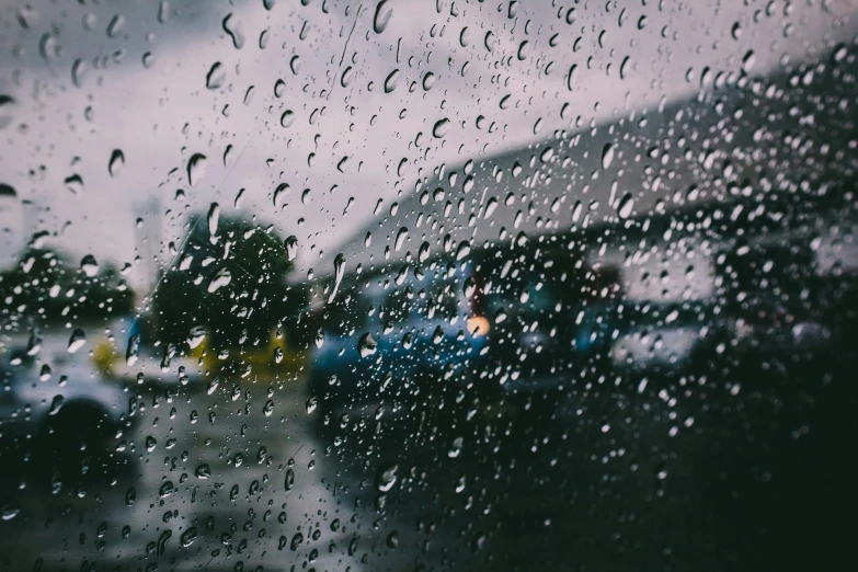 a view from a window in the rain on the road