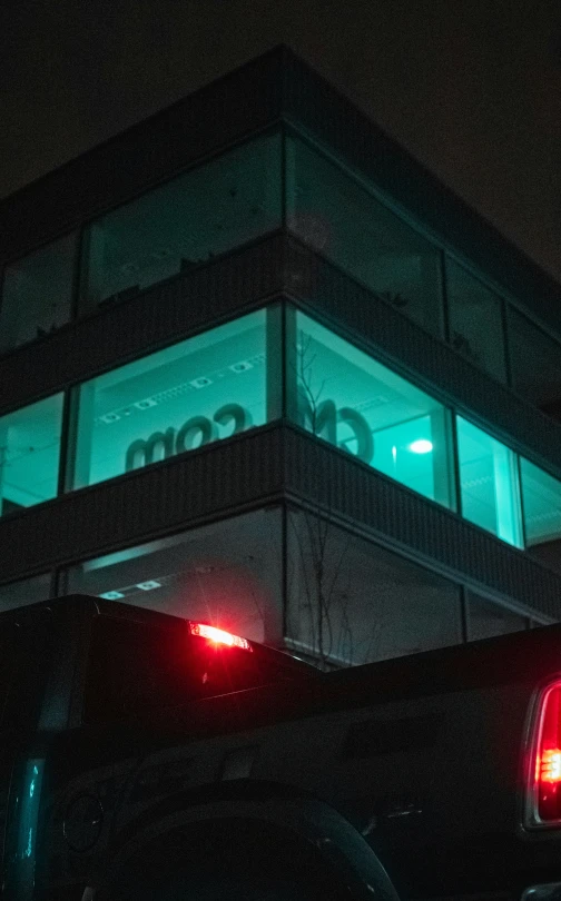 the top of a building that has some green lights