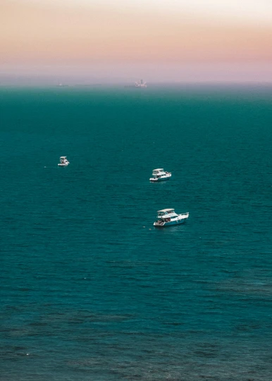 a group of boats floating in a body of water
