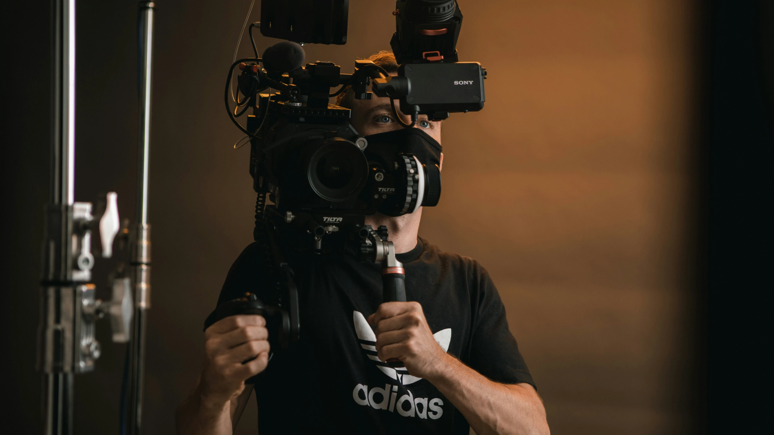 a camera man with several cameras strapped into his head
