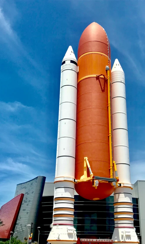 the giant rocket is made out of two orange and white pipes