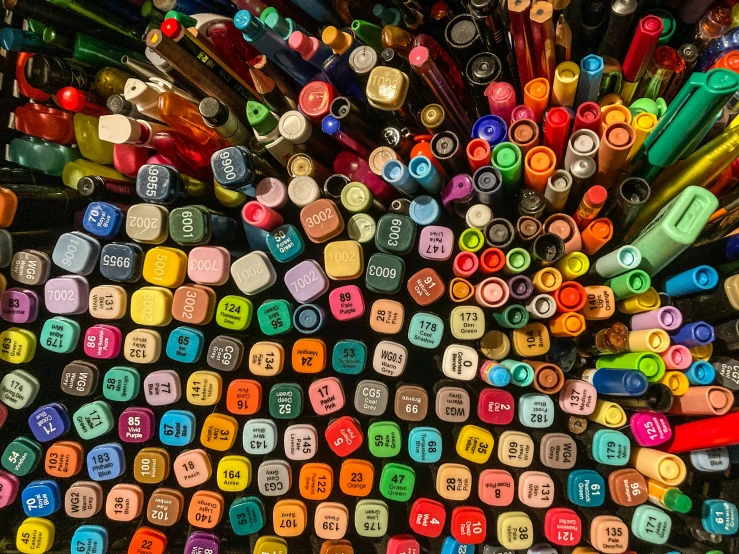 an artistic display of colorful crayons and markers