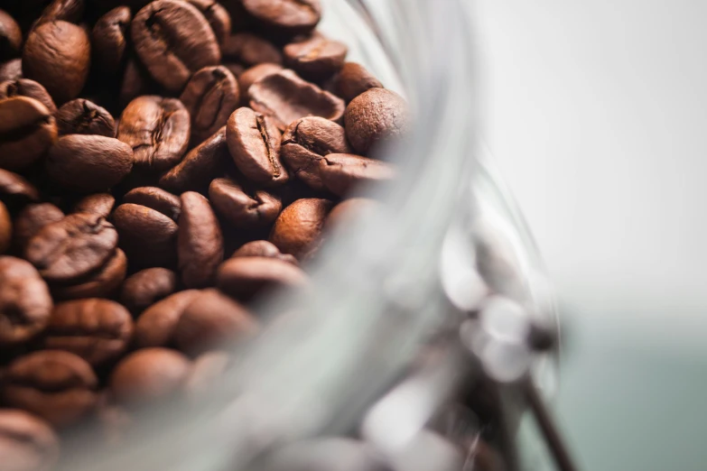 coffee beans inside a glass cup filled with coffee