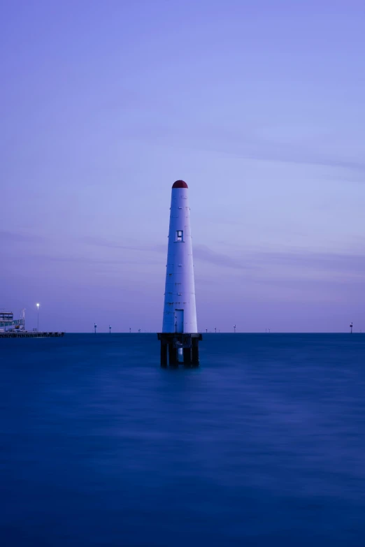 a light house sits on the edge of the water