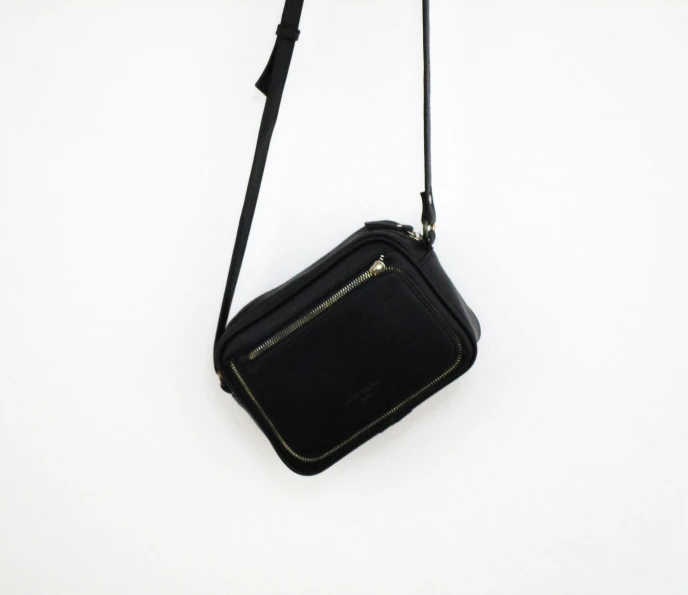 a small black purse with an adjustable handle