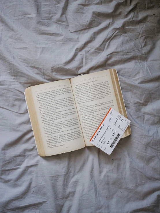 a book is laying open on top of a bed