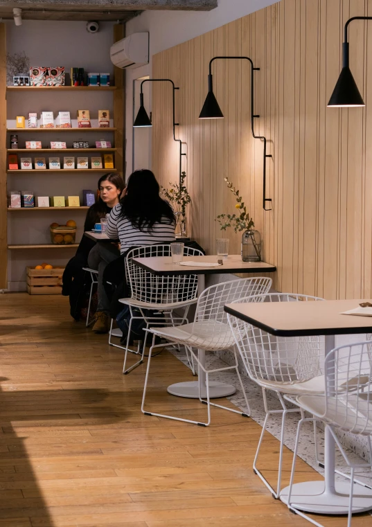 a room that has several white chairs sitting next to each other