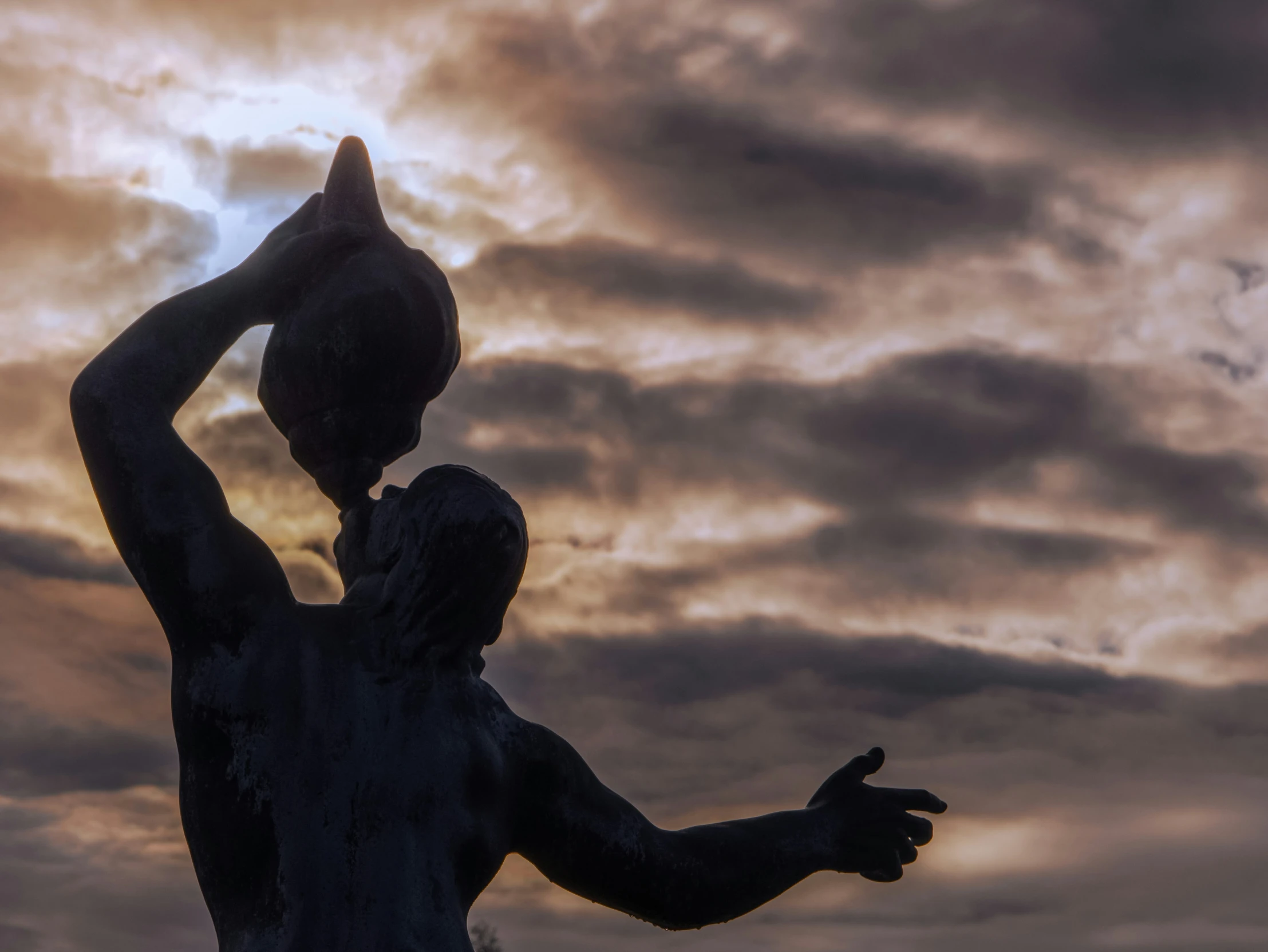 statue of a man holding a bird on his shoulders