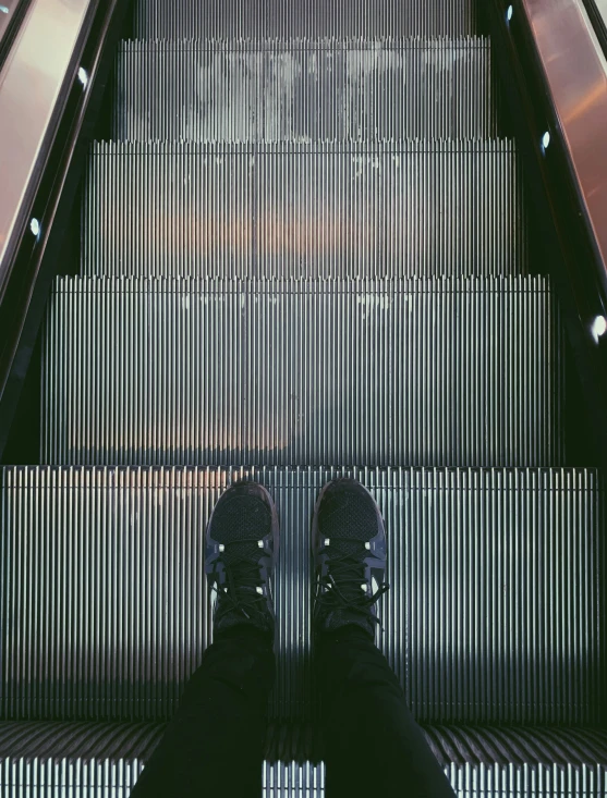 a person's foot is shown on the escalator