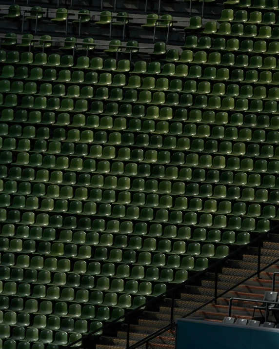 a person wearing an orange shirt is watching a tennis game