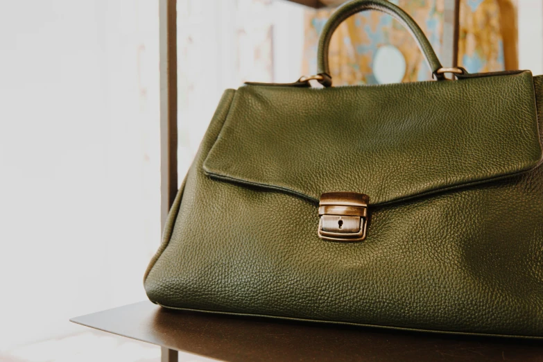 a close up of a green leather bag