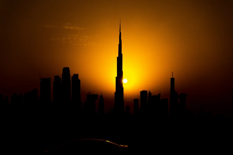 the sun rising over the city with tall buildings