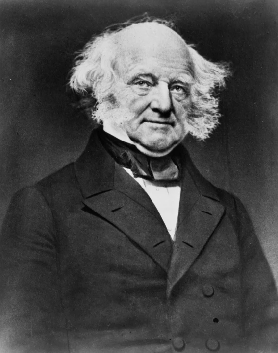 an old black and white pograph of a man with long hair