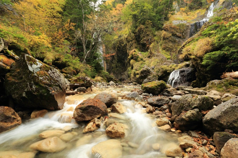 there is a river flowing near some rocks