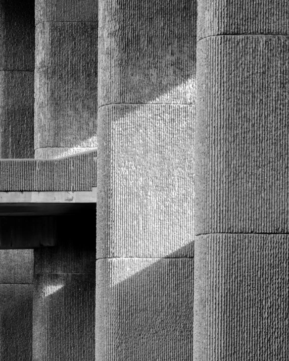 a black and white po of some walls and a person on a skateboard