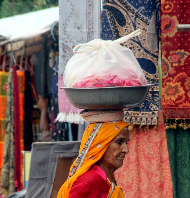 a woman walking down the street with bags on her head