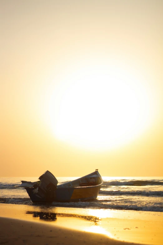 a boat sitting on top of a sandy beach