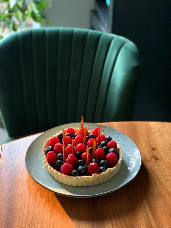 a decorative dessert on a table in front of an open green chair