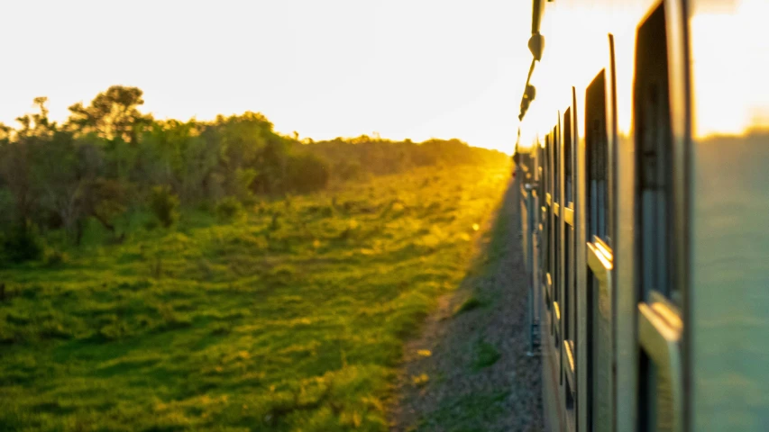 a po taken from inside the back of a train at sunrise