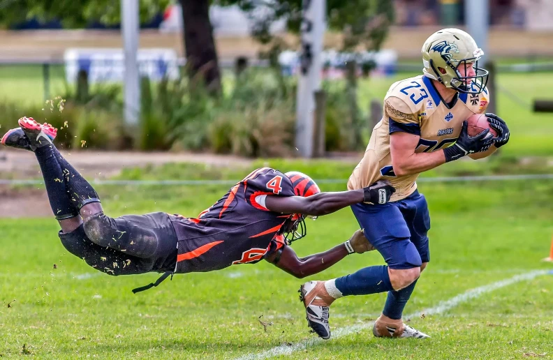 two football players are on the field playing in the game