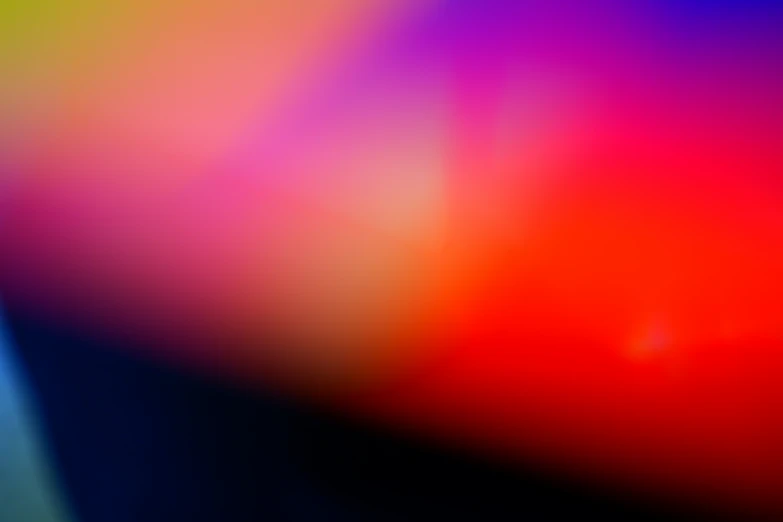 a blurry pograph of a red, yellow and blue background