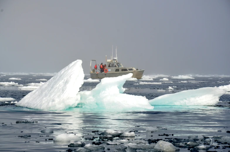 a boat that is floating through some ice