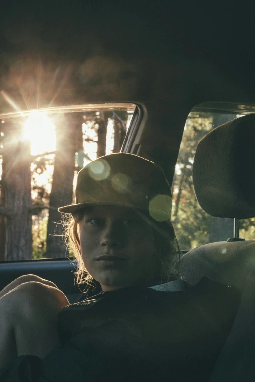 the back seat of a car shows the sunlight and trees