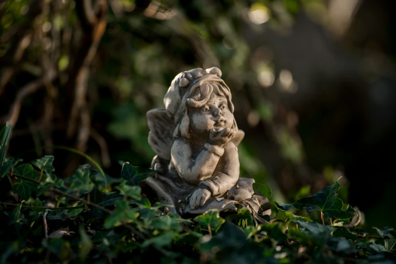 a statue of an elephant is sitting in a bush