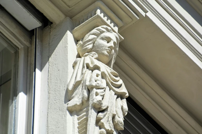 a concrete figure on the side of a building