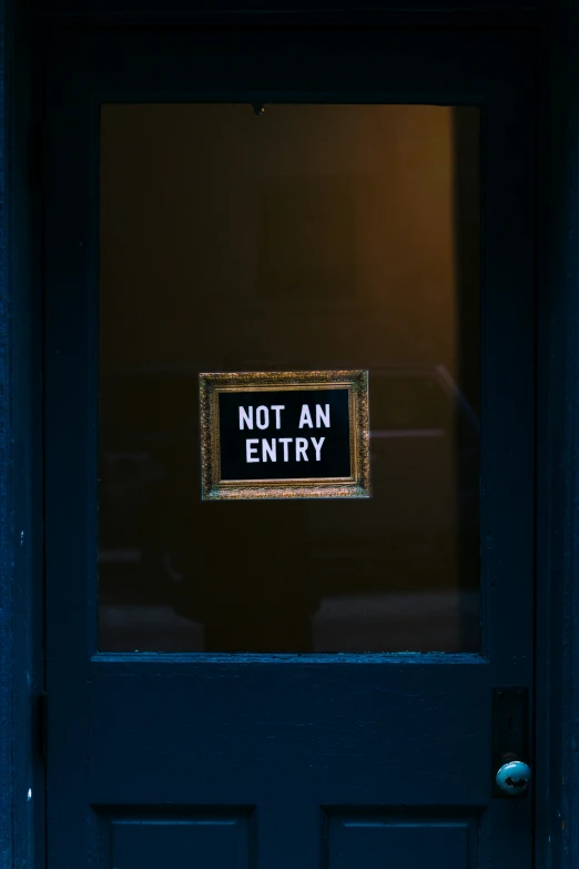 a not an entry sign hanging in front of a door