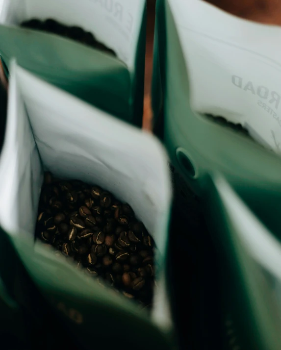 there are two coffee bags with coffee beans in them