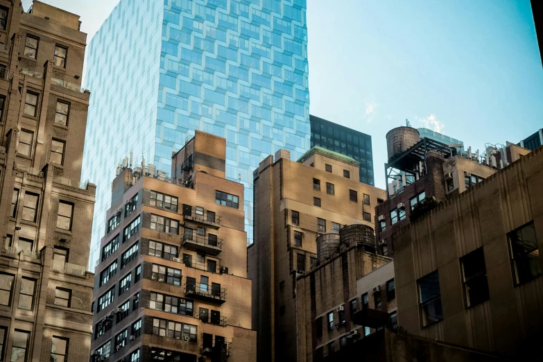 looking up at a tall building near another skyscr