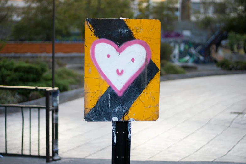 the sign is attached to a post by a fence