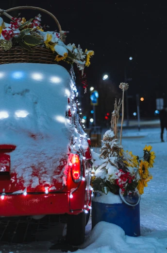 a truck covered in snow, surrounded by christmas decorations