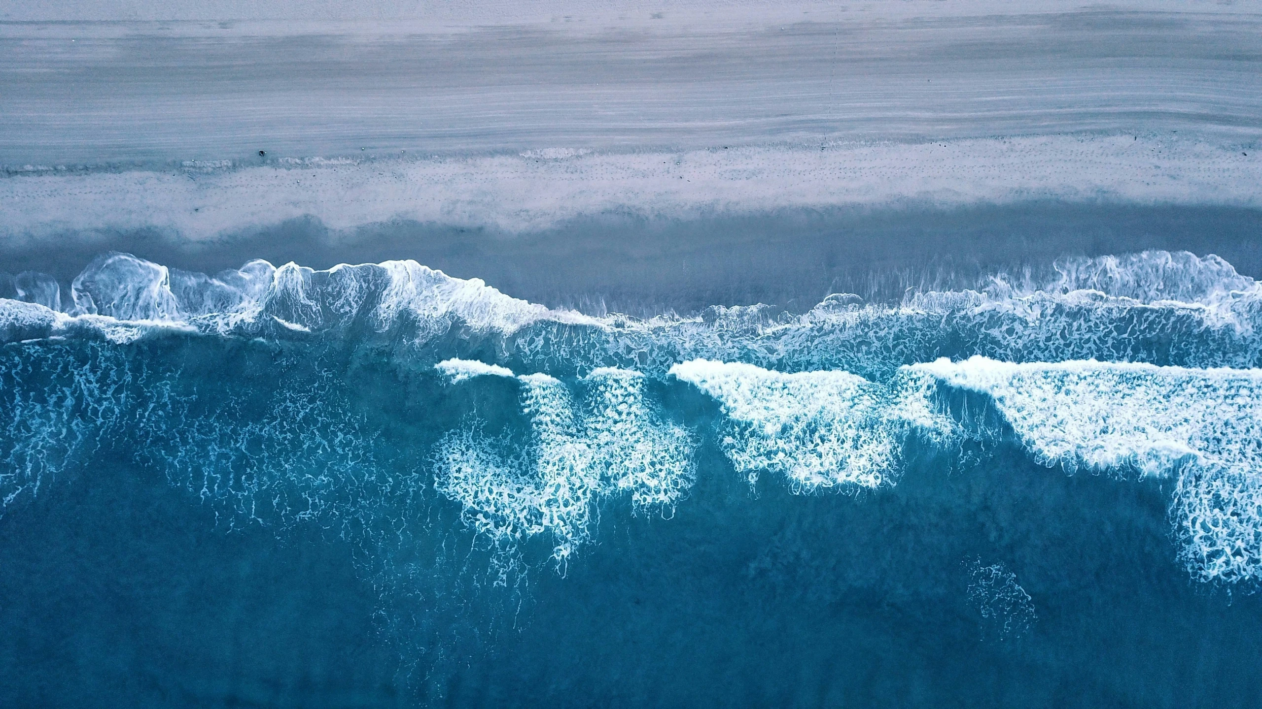 top view of waves and ocean in blue color