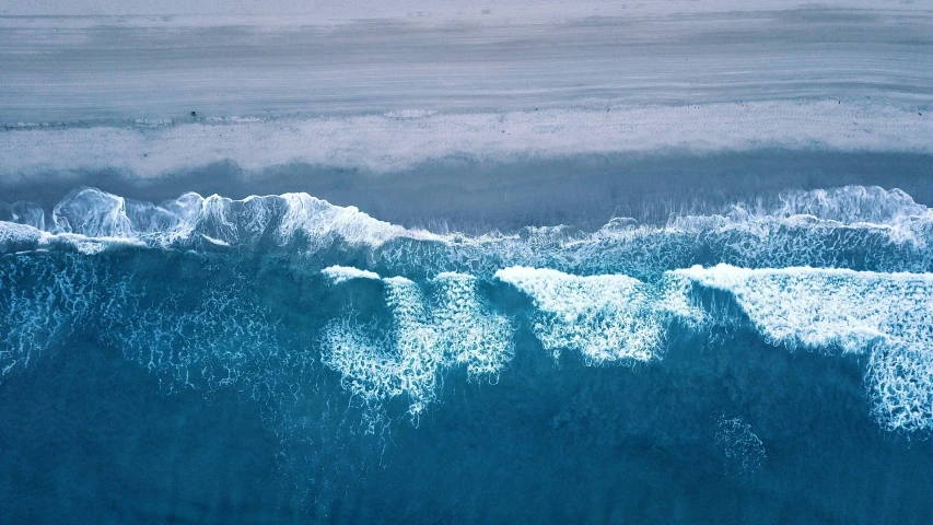 top view of waves and ocean in blue color