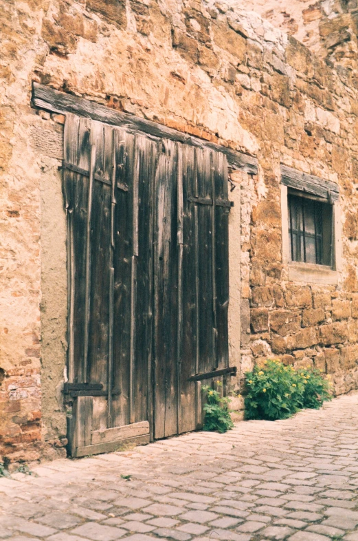 an old, weathered window with the door open