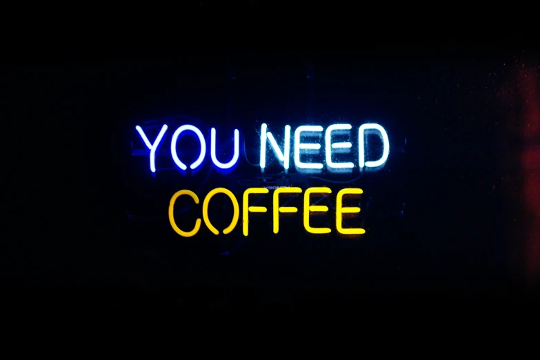 the neon sign reads, you need coffee