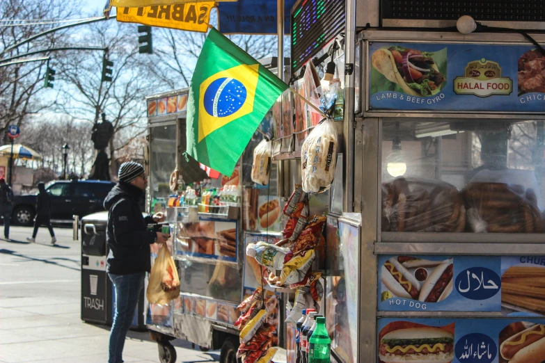 a man is buying food from a stall