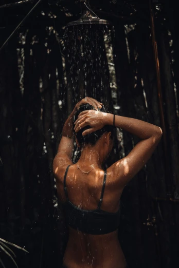 the woman is standing under a shower and has  on