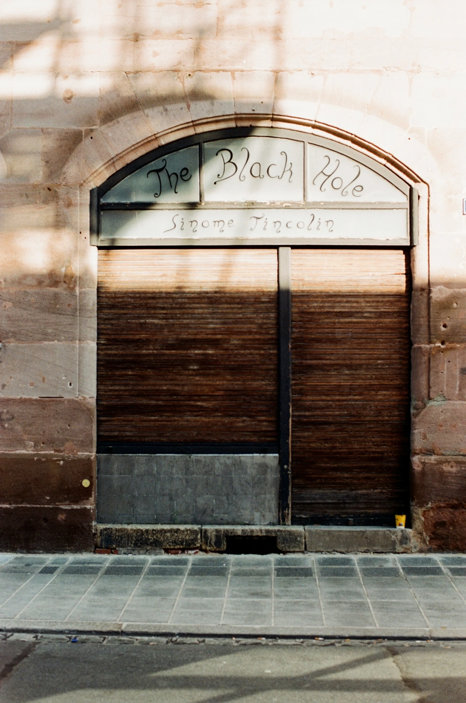 a brown door is open on the side of a building