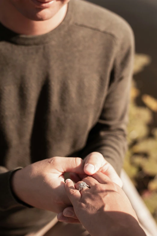 a young man holds the hand of an older lady