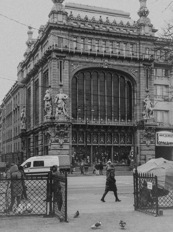 a person walking next to a large building on a street