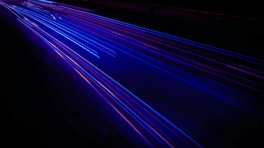 car lights streaking down a city street at night