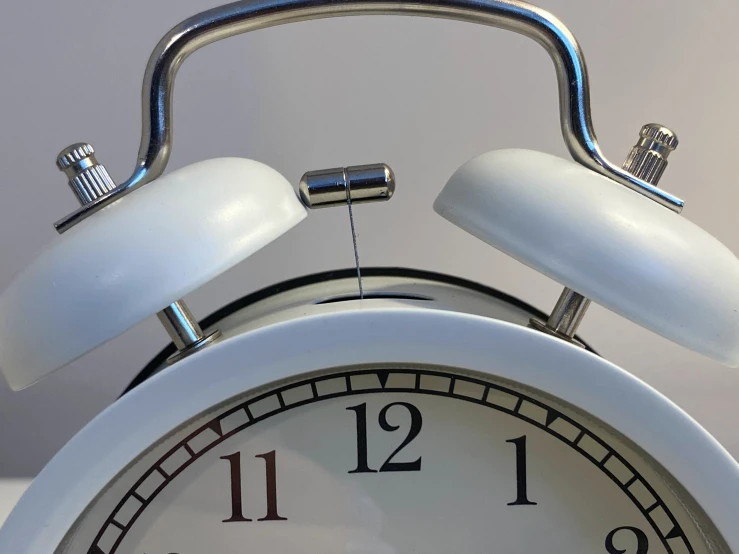an alarm clock showing one twenty seven behind the clock