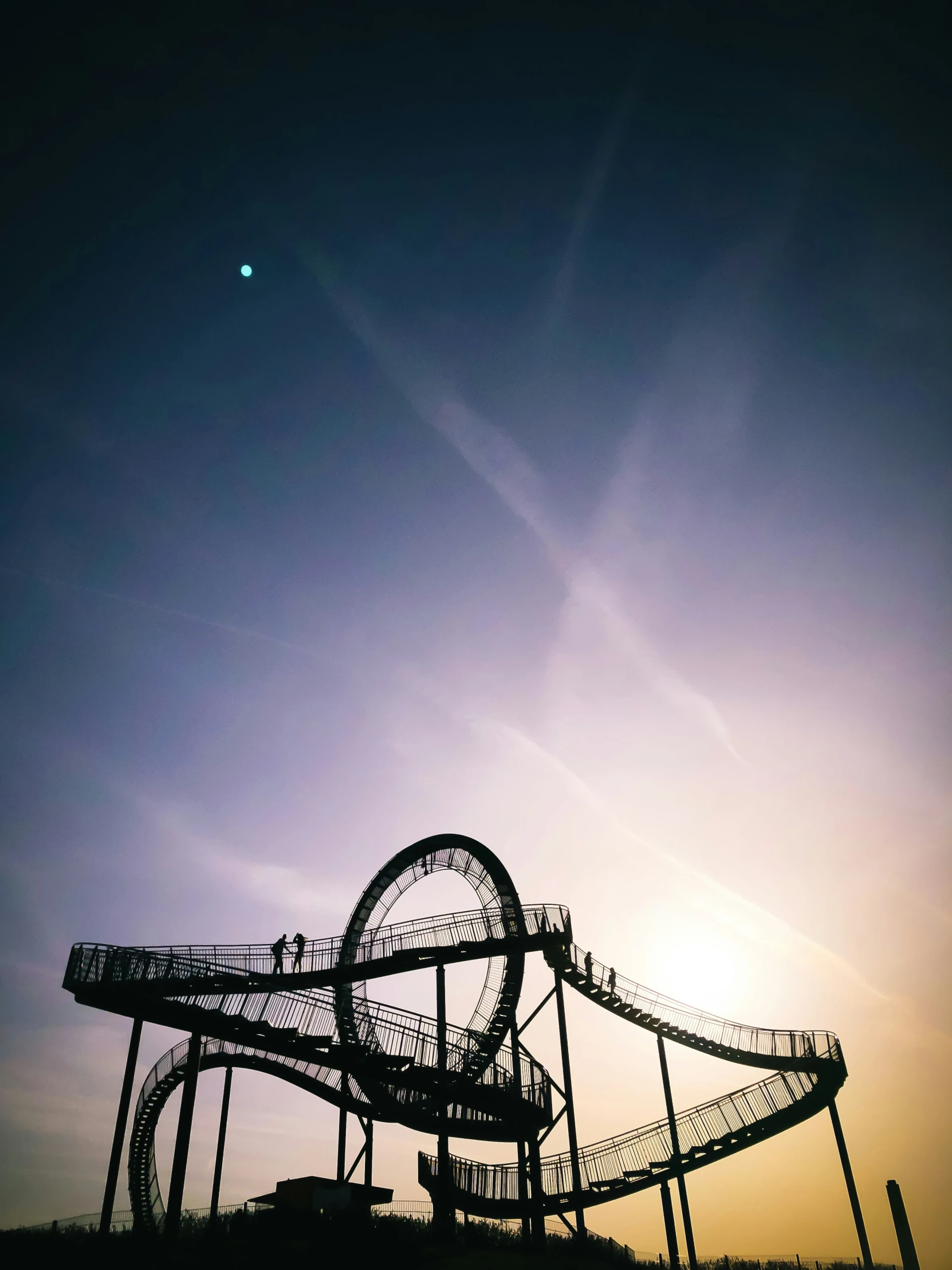 the roller coaster at dusk, silhouetted against the sky